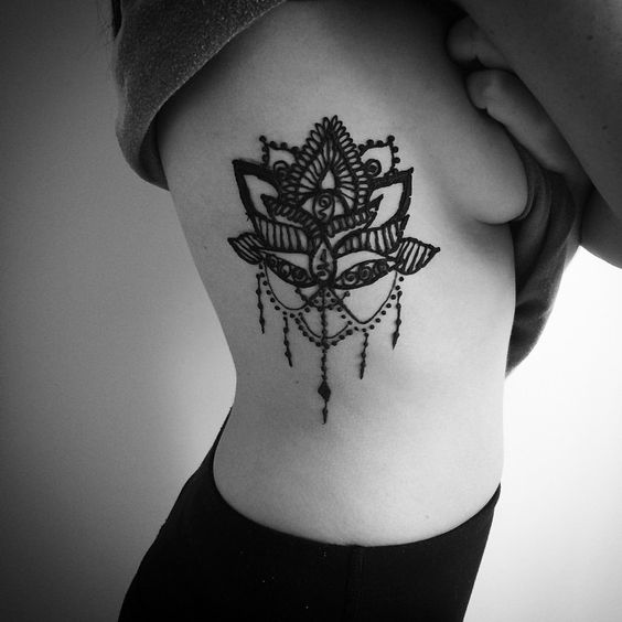 #Lotus #Flower #Tattoo Attractive lotus flower rib tattoo design for girls