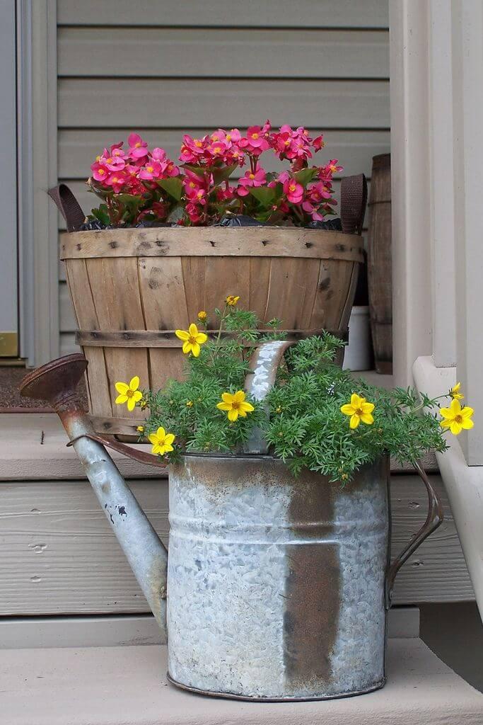 Turn An Old Wine Barrel And A Rusted Watering Can Into Planters.