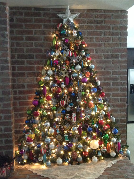 Amazing Christmas wall tree of garland decorated with colorful ornaments.