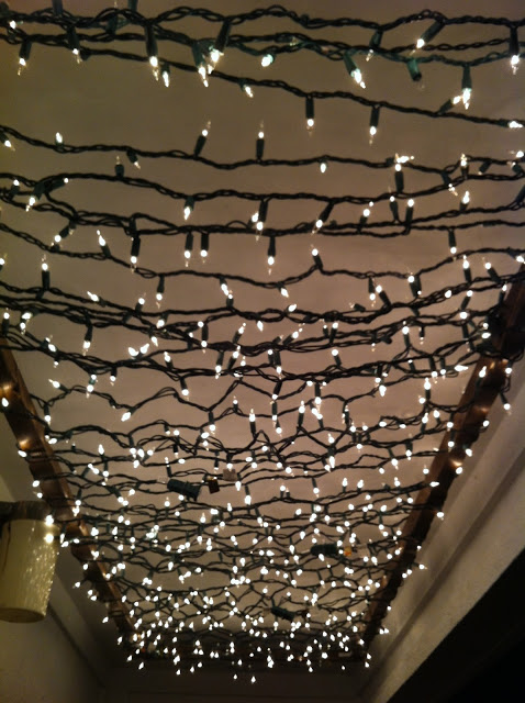 Christmas lights create a twinkle light porch canopy.