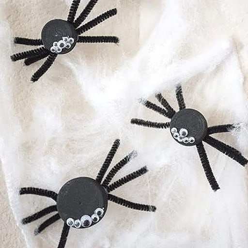 Crawly spiders made by these painted milk lids, added googly eyes, and pipe cleaners.