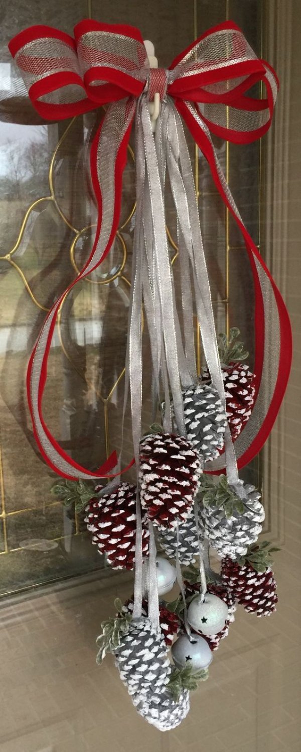 Gorgeous painted red and silver snow dipped pine cones wreath with silver bells and red ribbon.