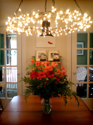 Wrap your chandelier with a generous amount of Christmas lights.