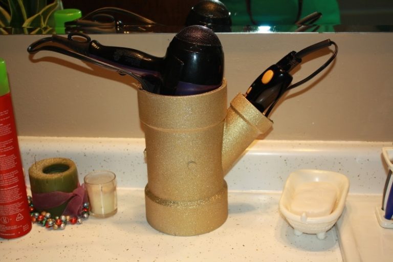 PVC pipe painted and used as hair dryer holder.