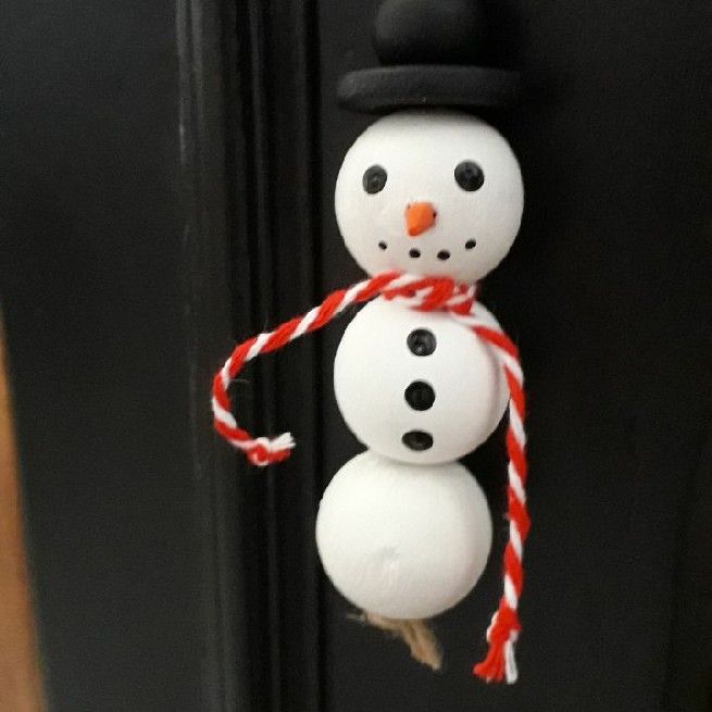 Snowman in wood beads.