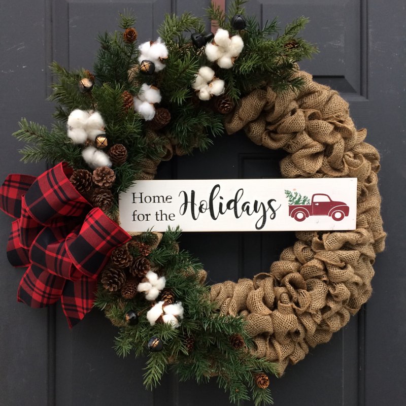 Home for the holidays with greenery, pine cones, cotton.