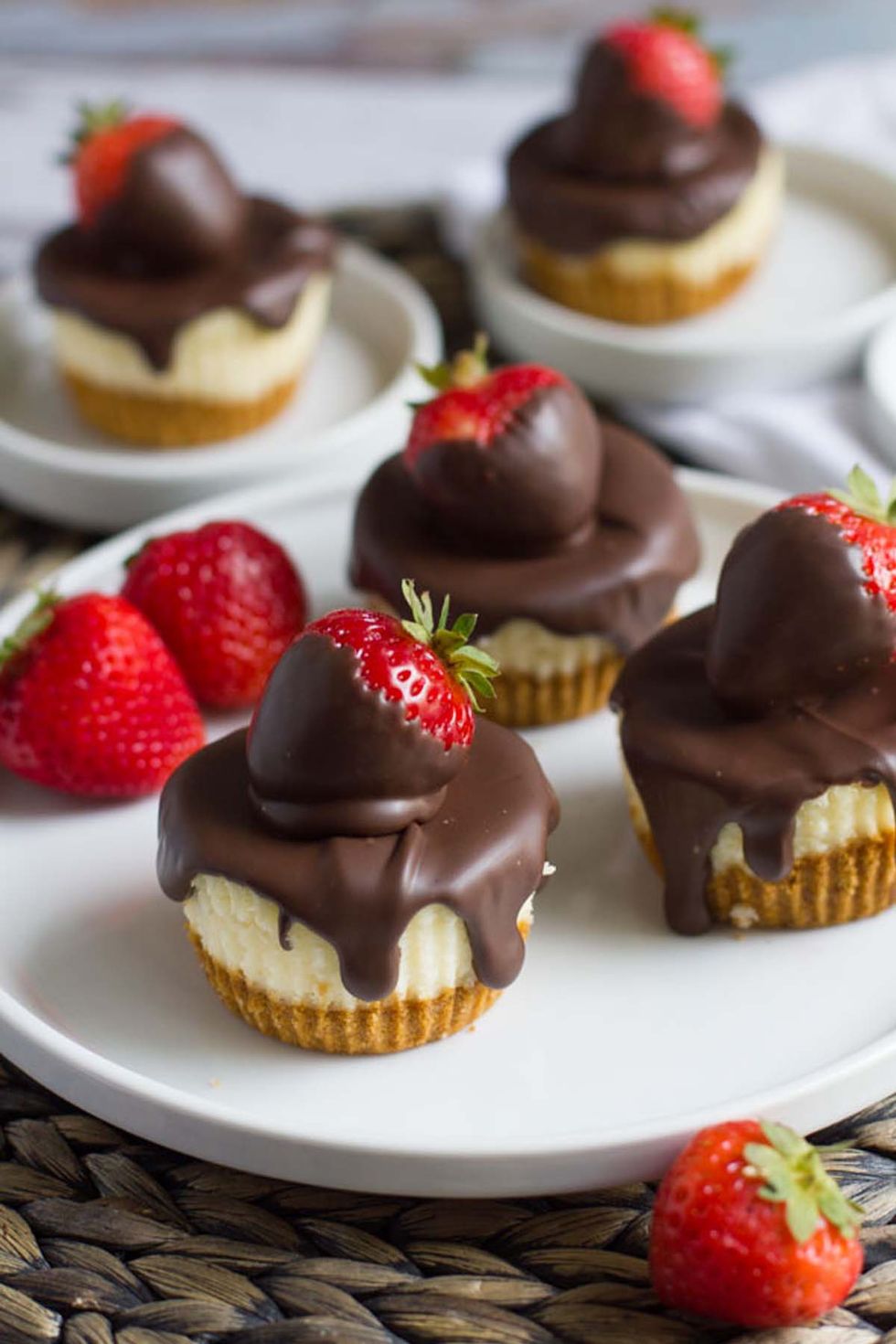 Mini Chocolate-Covered Strawberry Cheesecakes.
